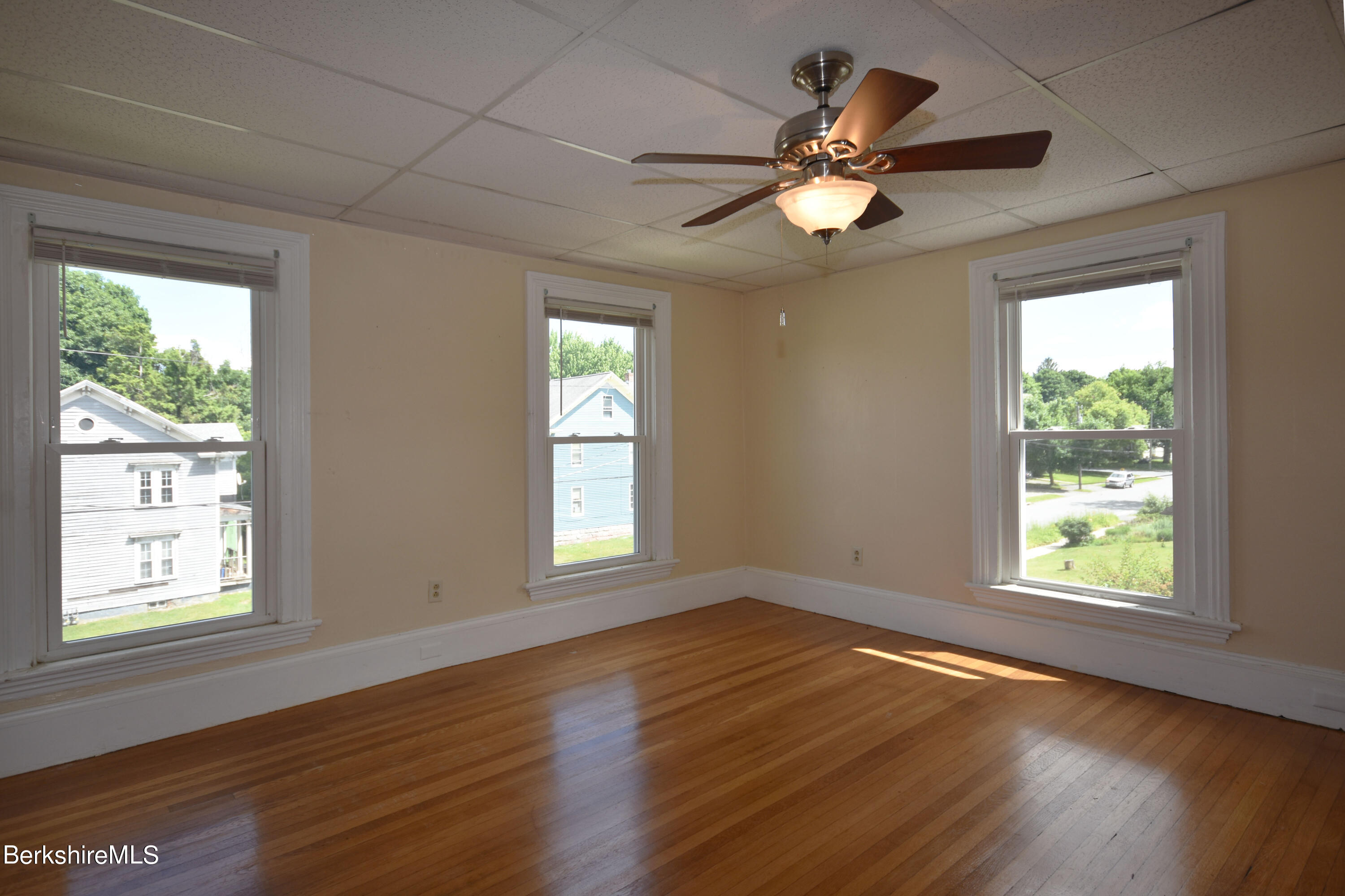26 Elizabeth Street Pittsfield, MA 01201 - Photo 28 of 43 a view of an empty room with wooden floor and a window