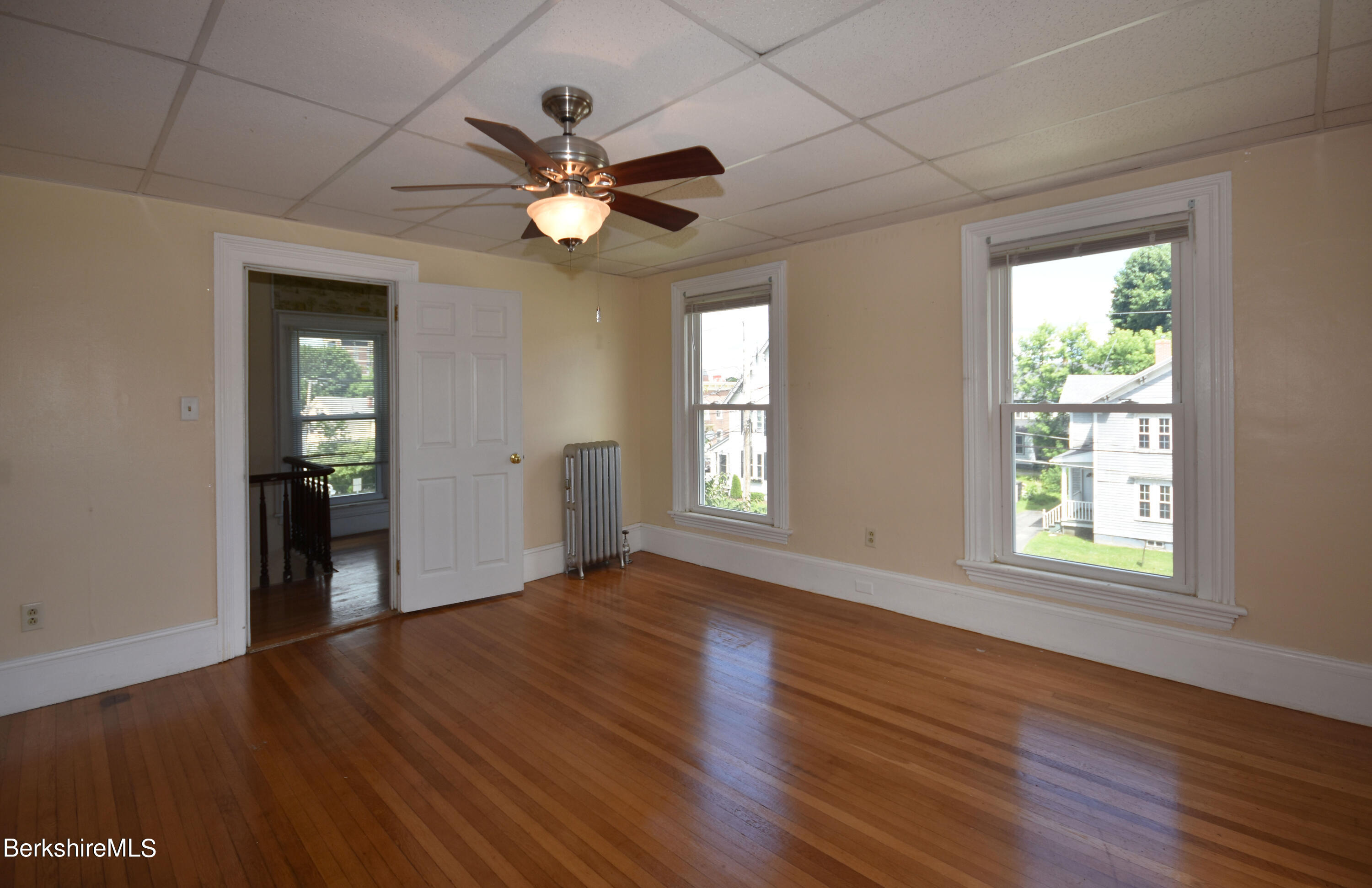 26 Elizabeth Street Pittsfield, MA 01201 - Photo 29 of 43 a view of an empty room with wooden floor and a window
