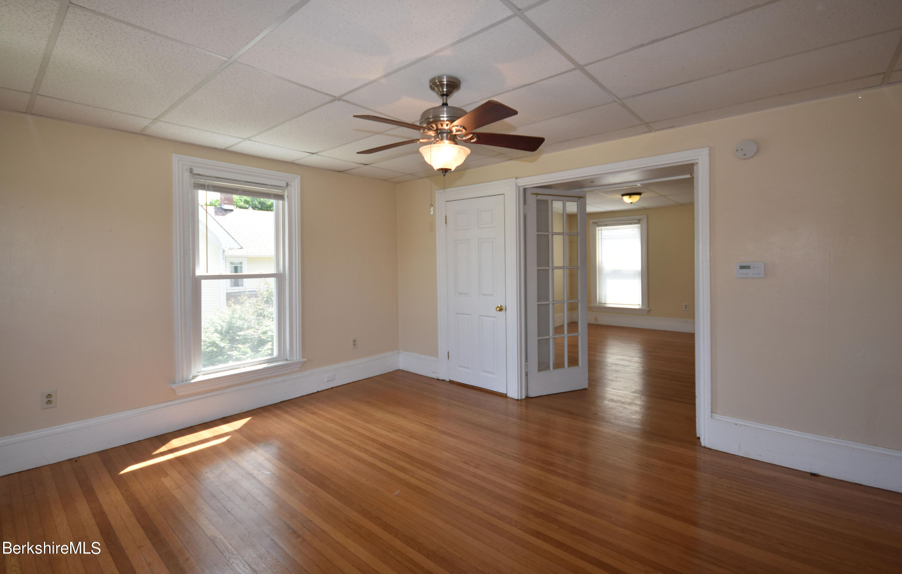 26 Elizabeth Street Pittsfield, MA 01201 - Photo 31 of 43 a view of an empty room with window and wooden floor