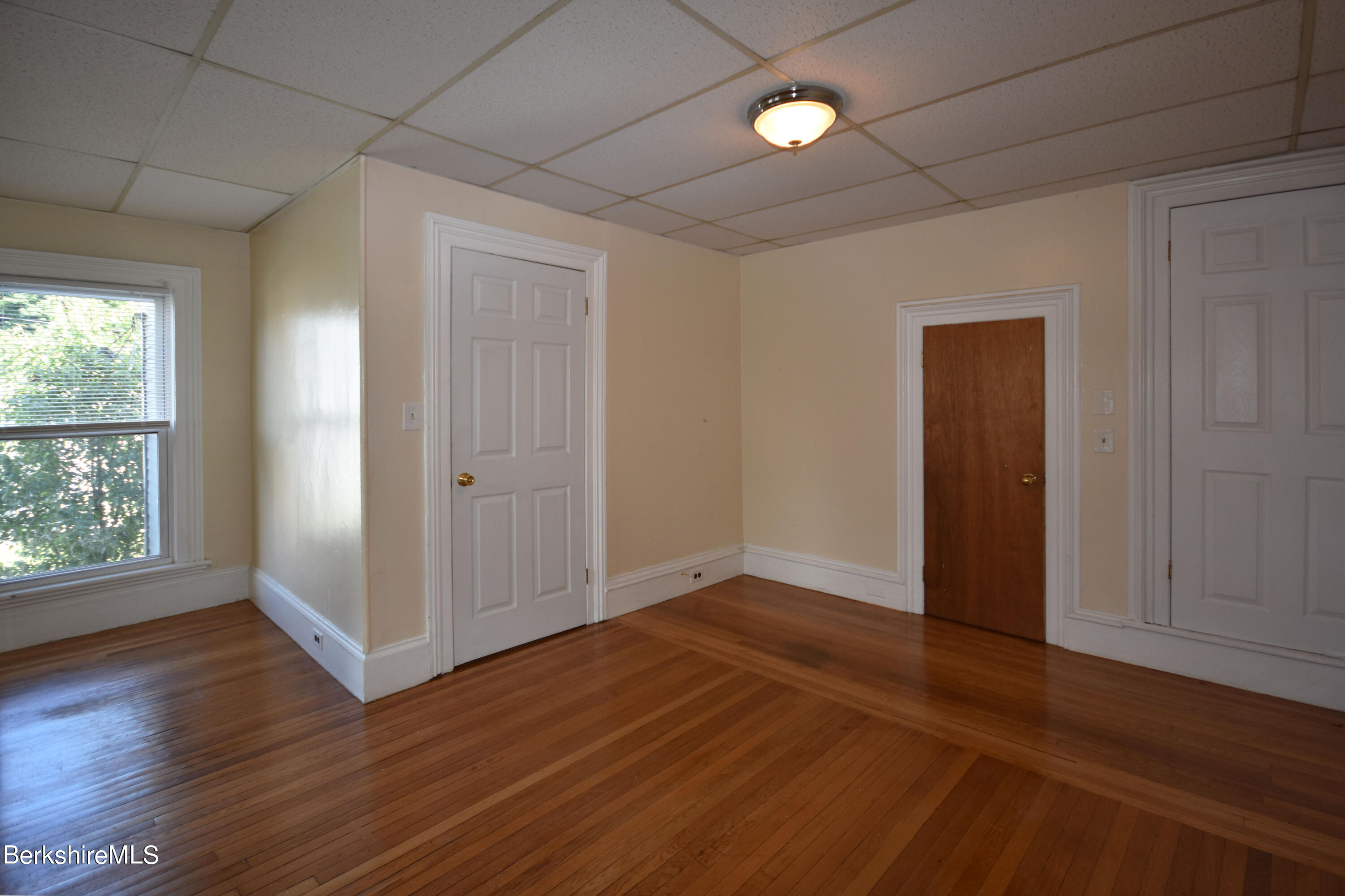 26 Elizabeth Street Pittsfield, MA 01201 - Photo 32 of 43 an empty room with wooden floor and windows