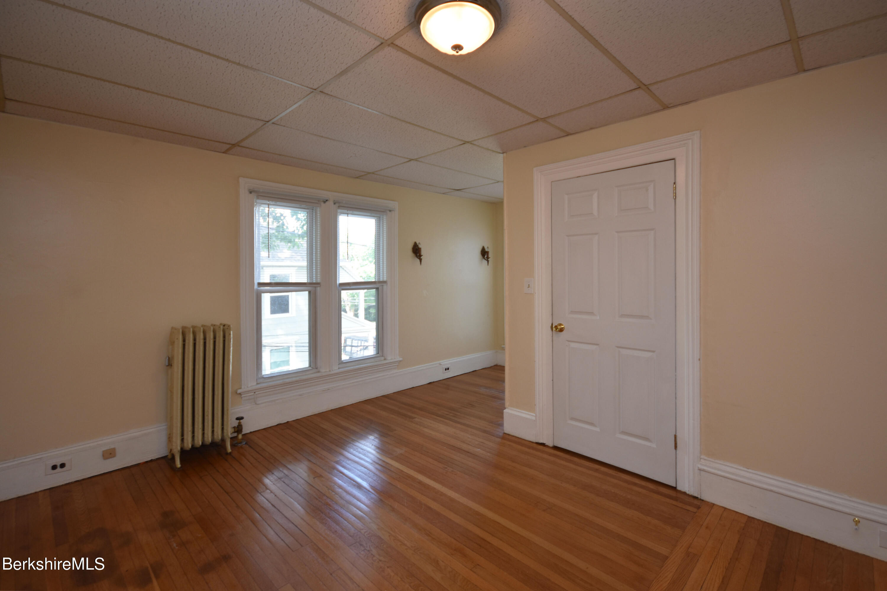 26 Elizabeth Street Pittsfield, MA 01201 - Photo 33 of 43 an empty room with wooden floor and windows