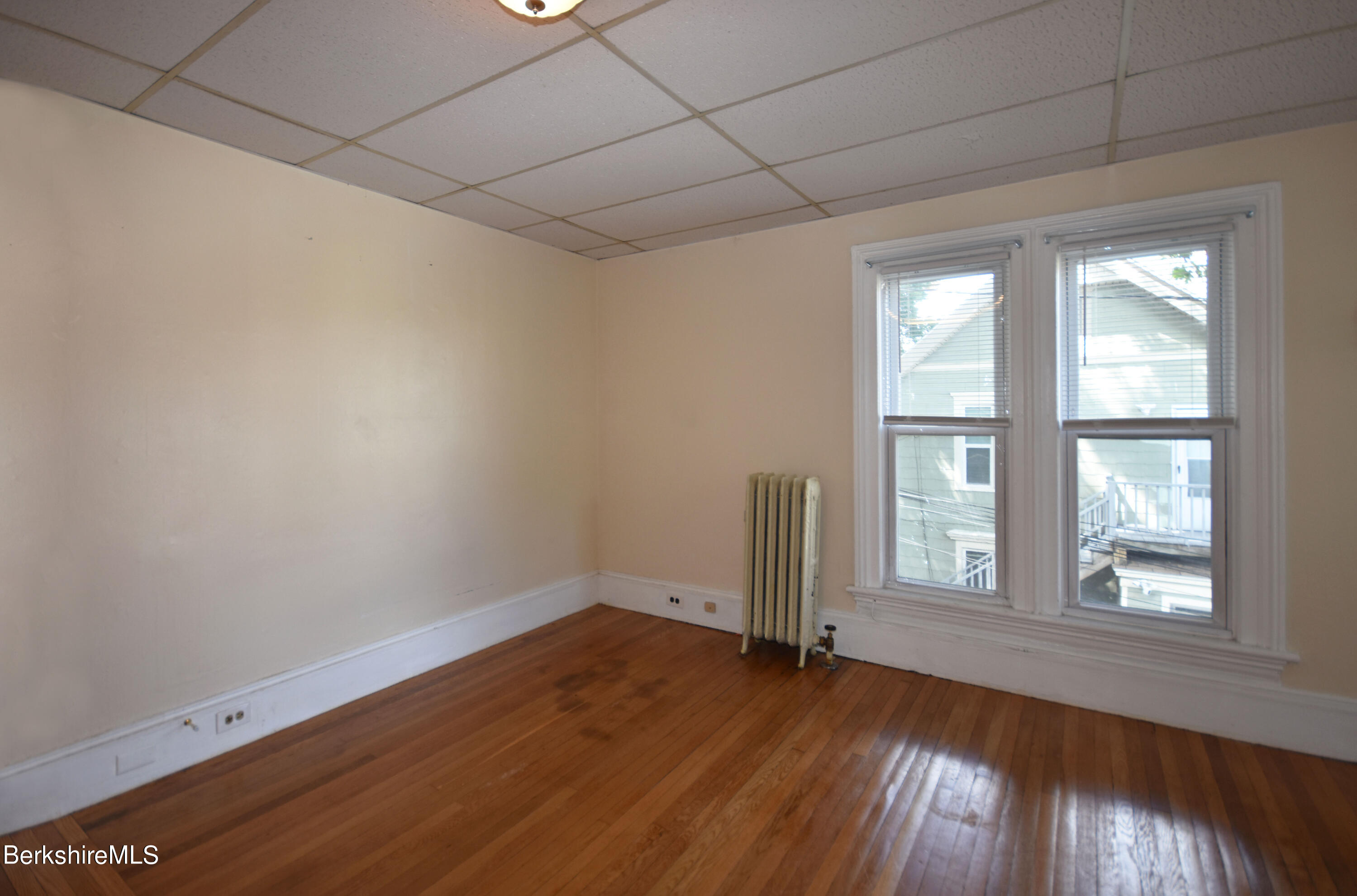 26 Elizabeth Street Pittsfield, MA 01201 - Photo 34 of 43 an empty room with wooden floor and windows
