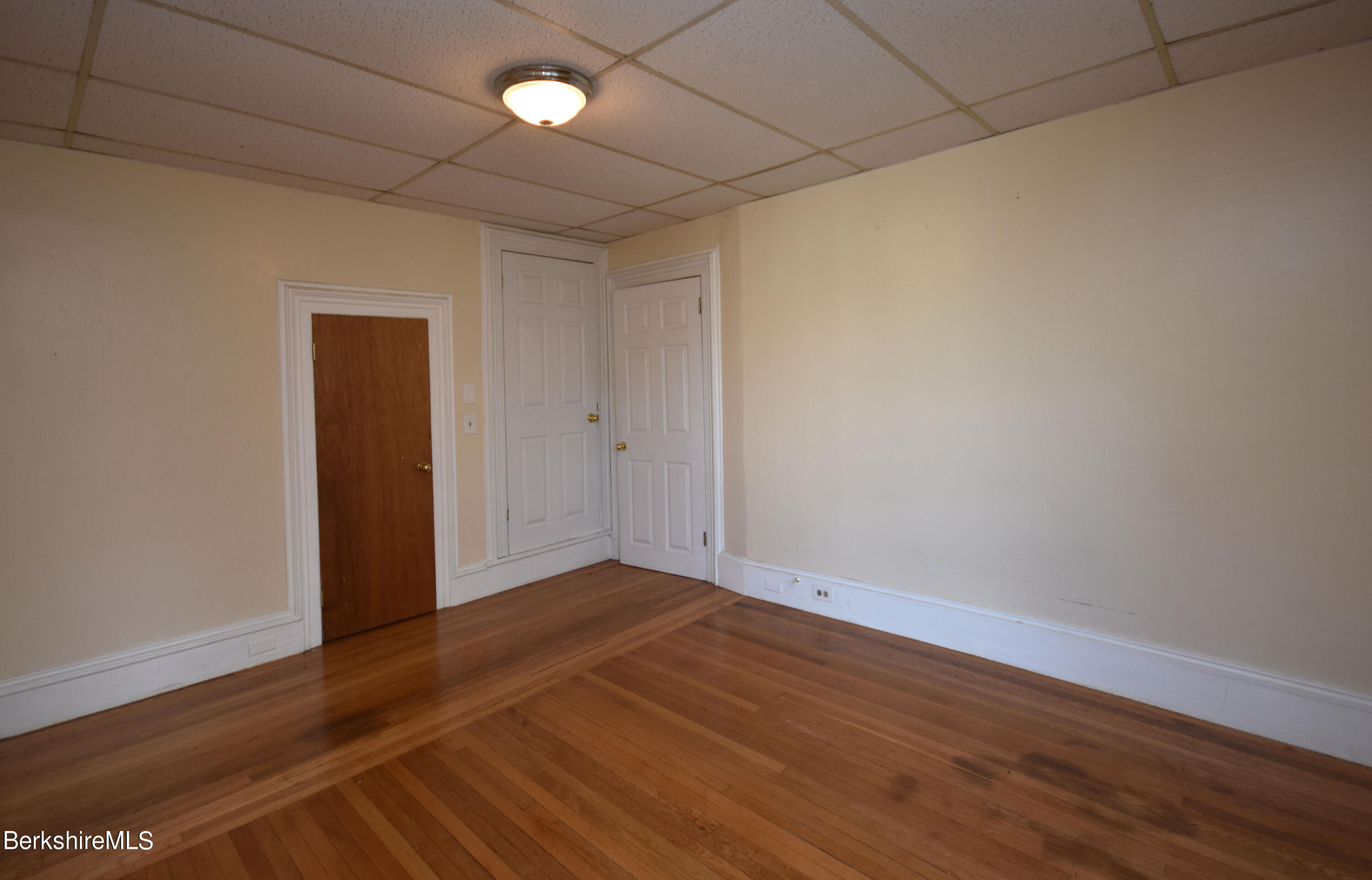 26 Elizabeth Street Pittsfield, MA 01201 - Photo 35 of 43 a view of an empty room with wooden floor