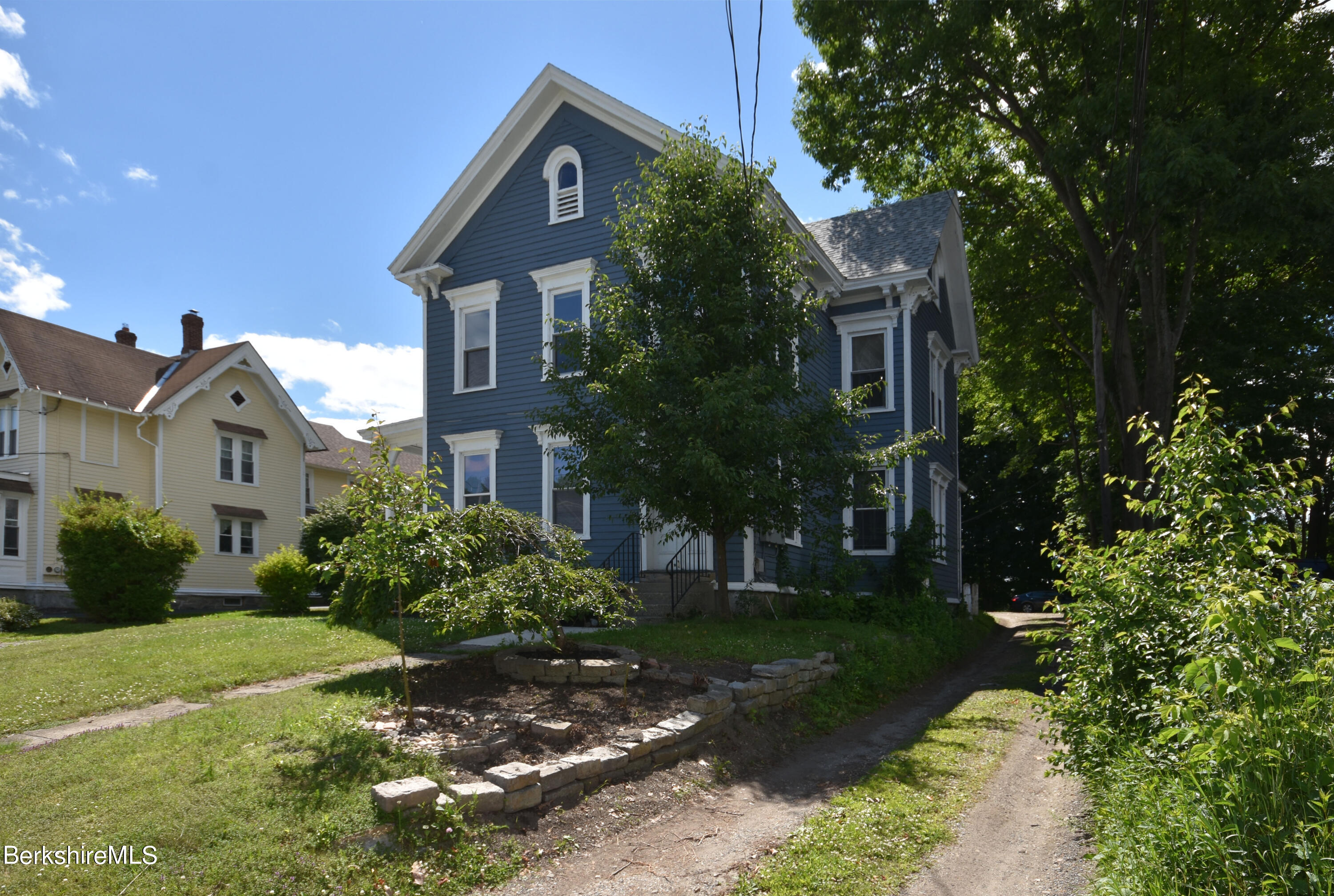 26 Elizabeth Street Pittsfield, MA 01201 - Photo 5 of 43 a front view of a house with a yard and green space