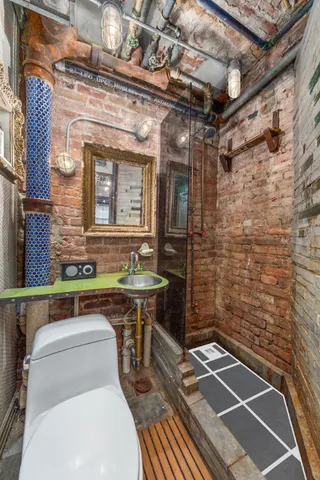 a bathroom with a toilet and a shower