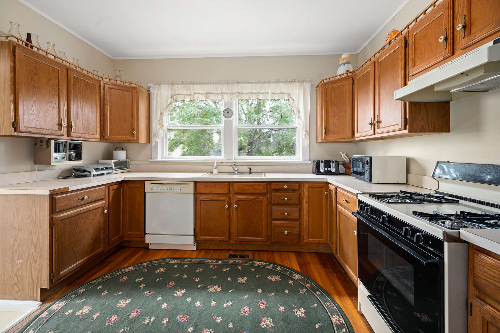 15346 Quigley Road Sycamore, IL 60178 - Photo 30 of 42 a kitchen with a sink stove top oven and cabinets