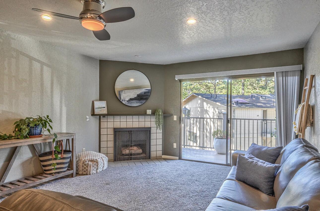 250 Forest Ridge Road, Unit 73 Monterey, CA 93940 - Photo 11 of 35 a living room with furniture a window and a fireplace
