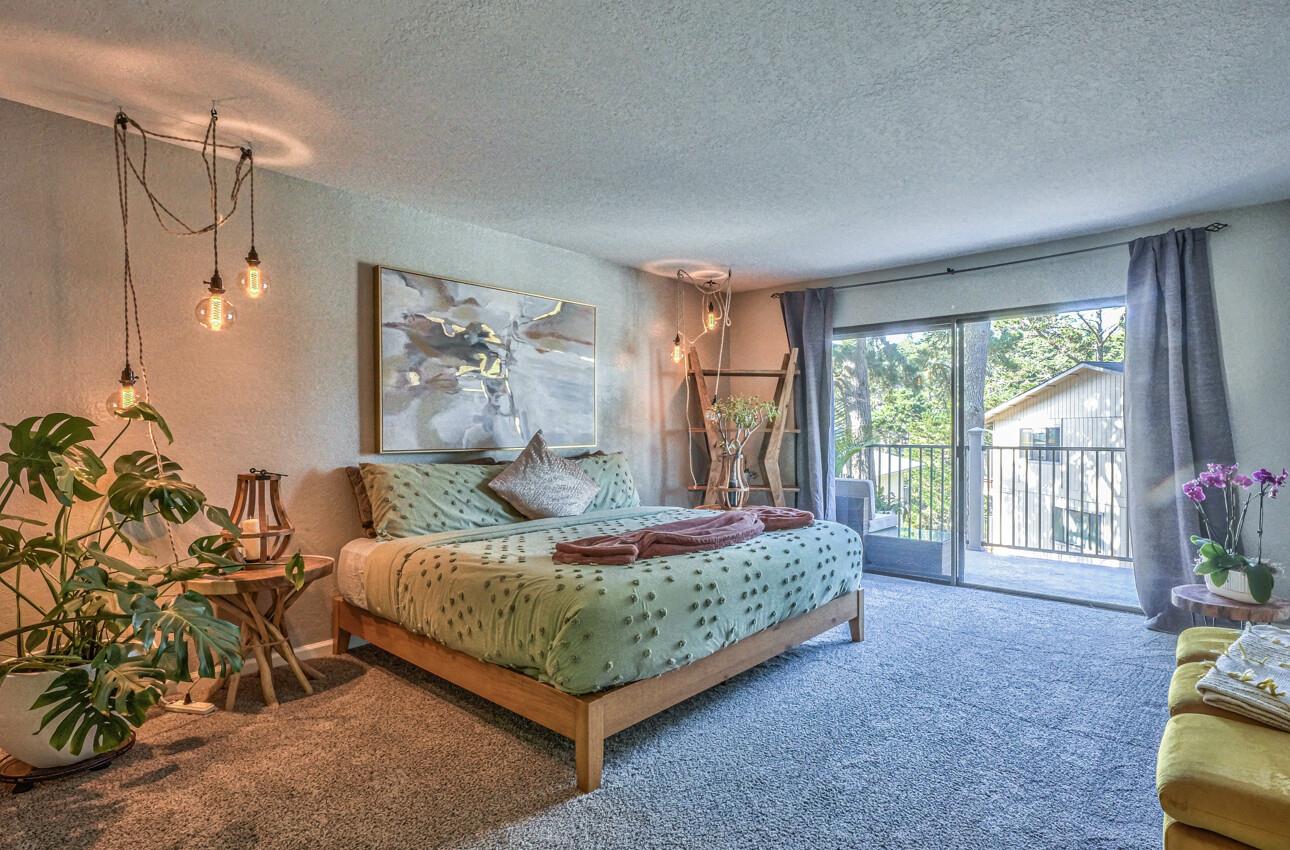 250 Forest Ridge Road, Unit 73 Monterey, CA 93940 - Photo 16 of 35 a bedroom with a bed mirror and a window