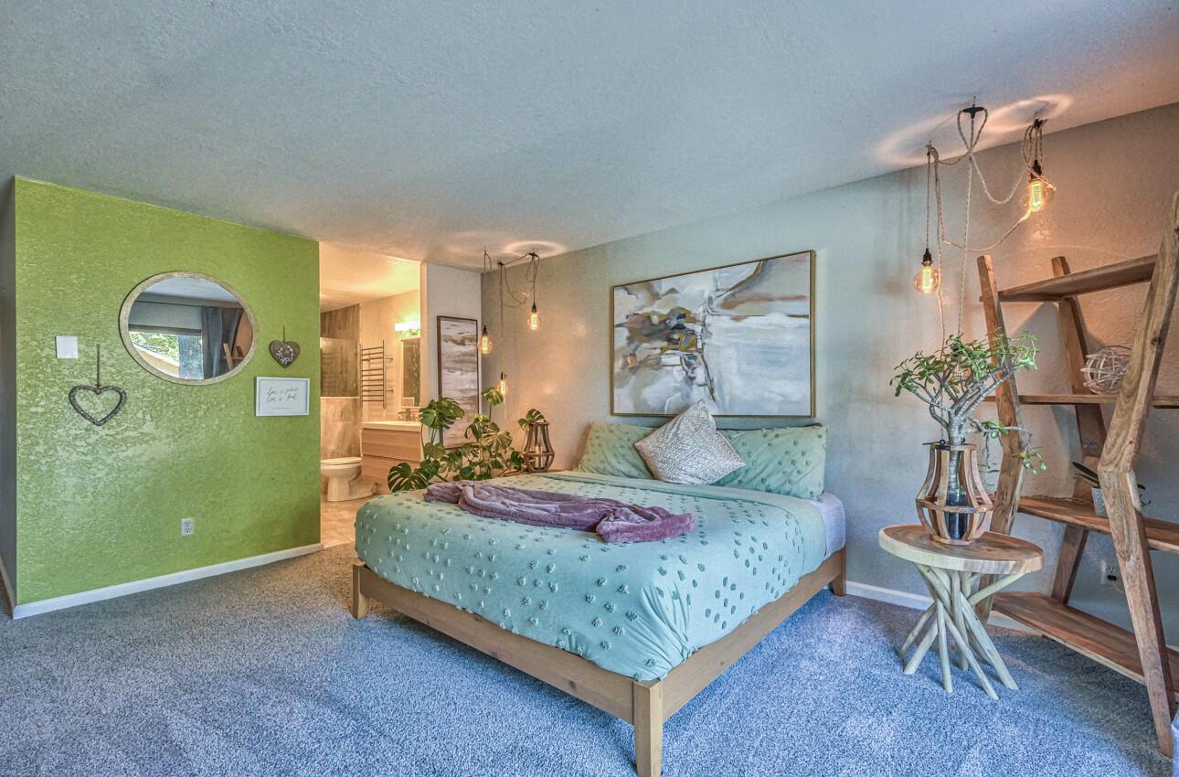 250 Forest Ridge Road, Unit 73 Monterey, CA 93940 - Photo 17 of 35 a bedroom with a bed and a table in it