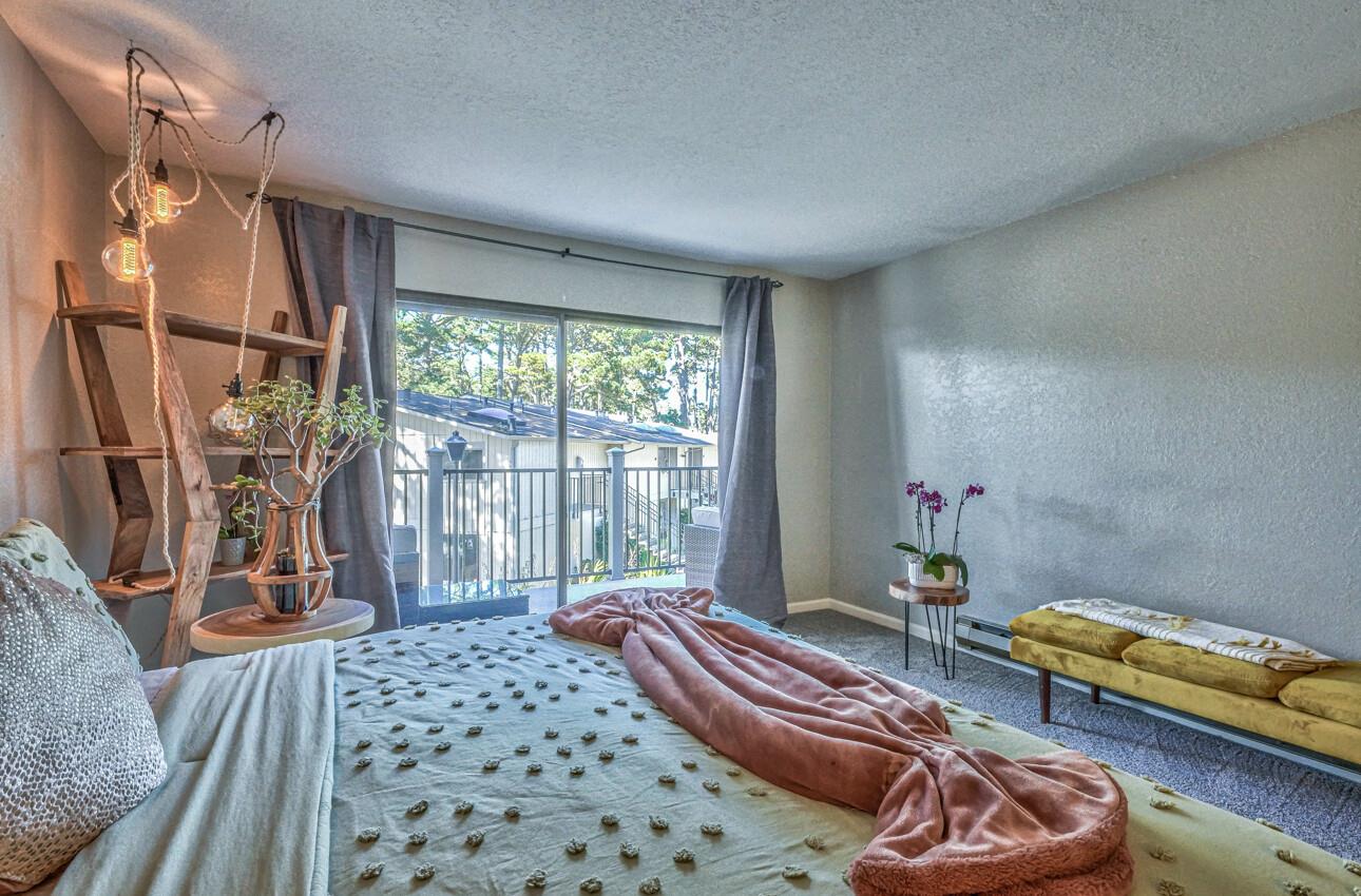 250 Forest Ridge Road, Unit 73 Monterey, CA 93940 - Photo 18 of 35 a bedroom with furniture and a window
