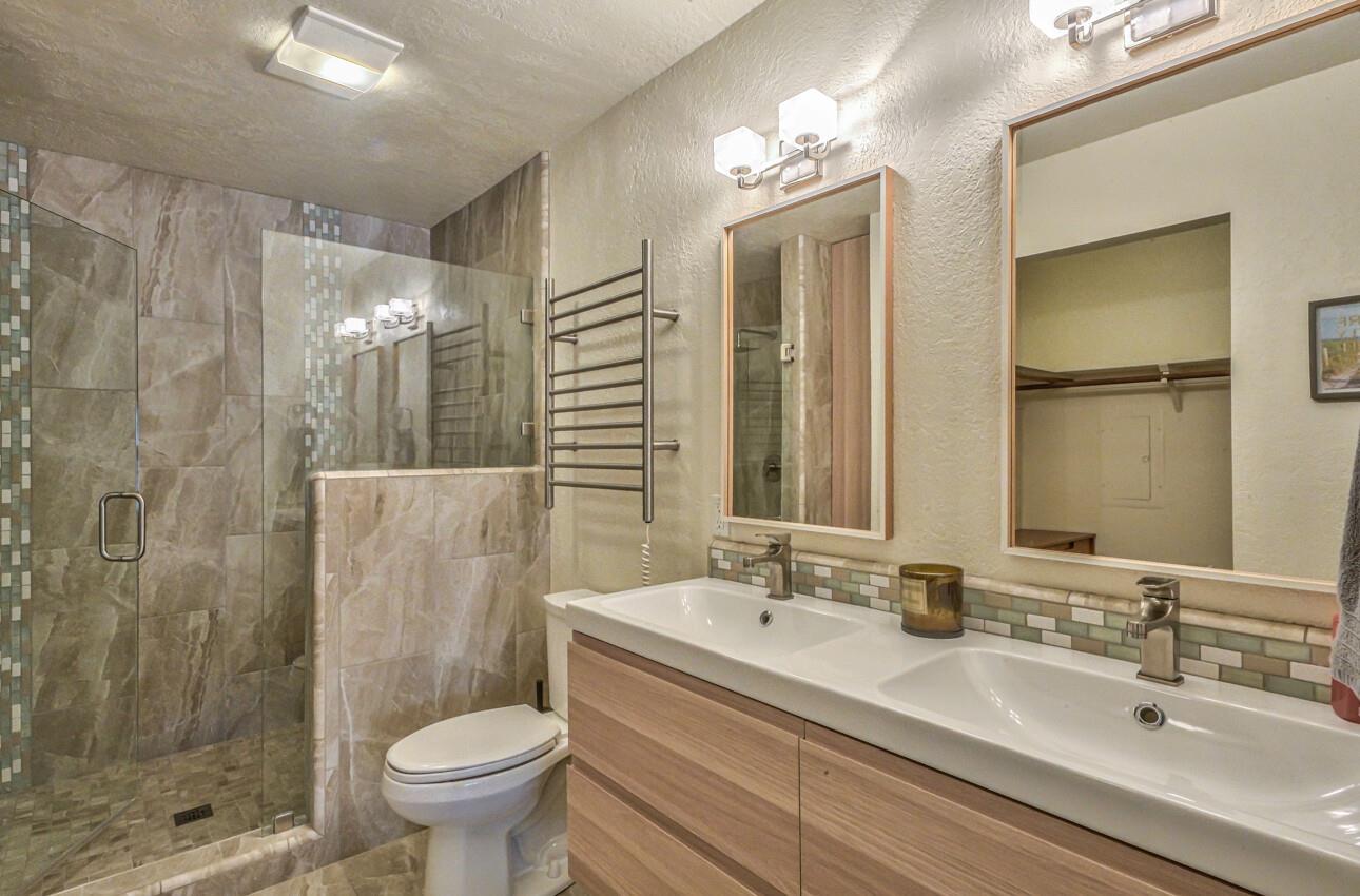 250 Forest Ridge Road, Unit 73 Monterey, CA 93940 - Photo 20 of 35 a bathroom with a double vanity sink toilet and shower