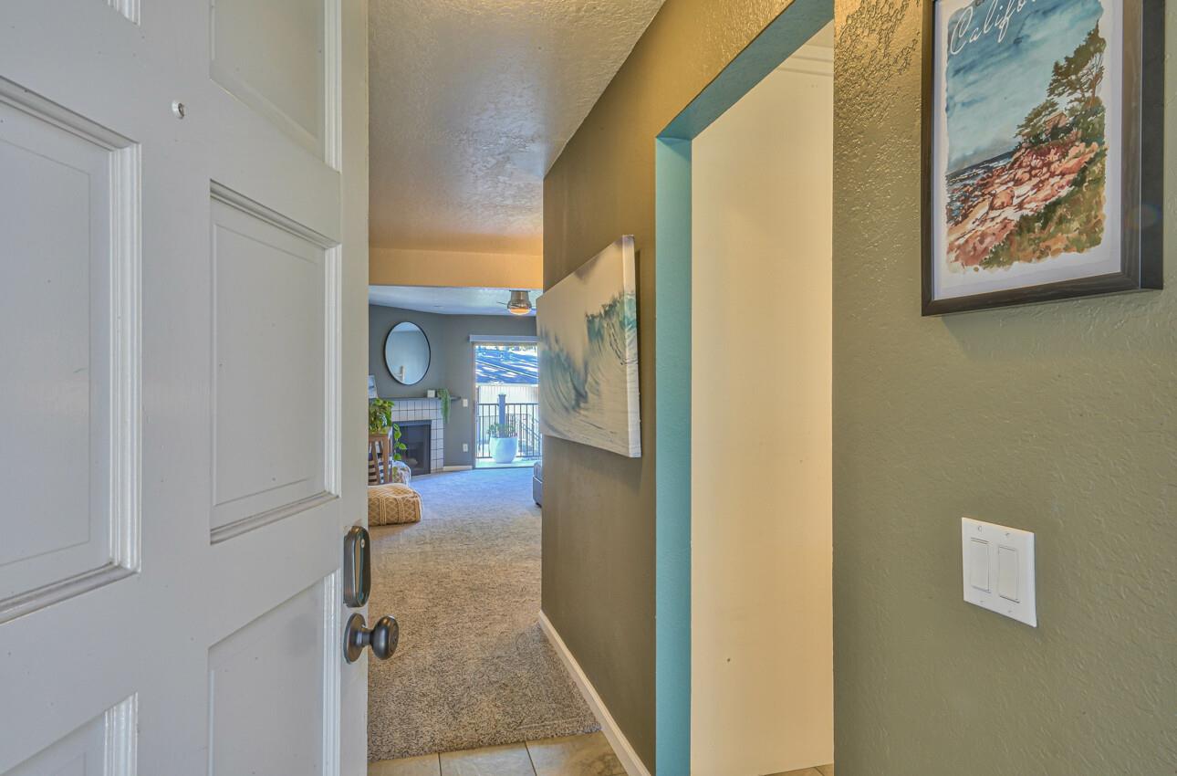 250 Forest Ridge Road, Unit 73 Monterey, CA 93940 - Photo 23 of 35 a view of a hallway with paintings on the wall