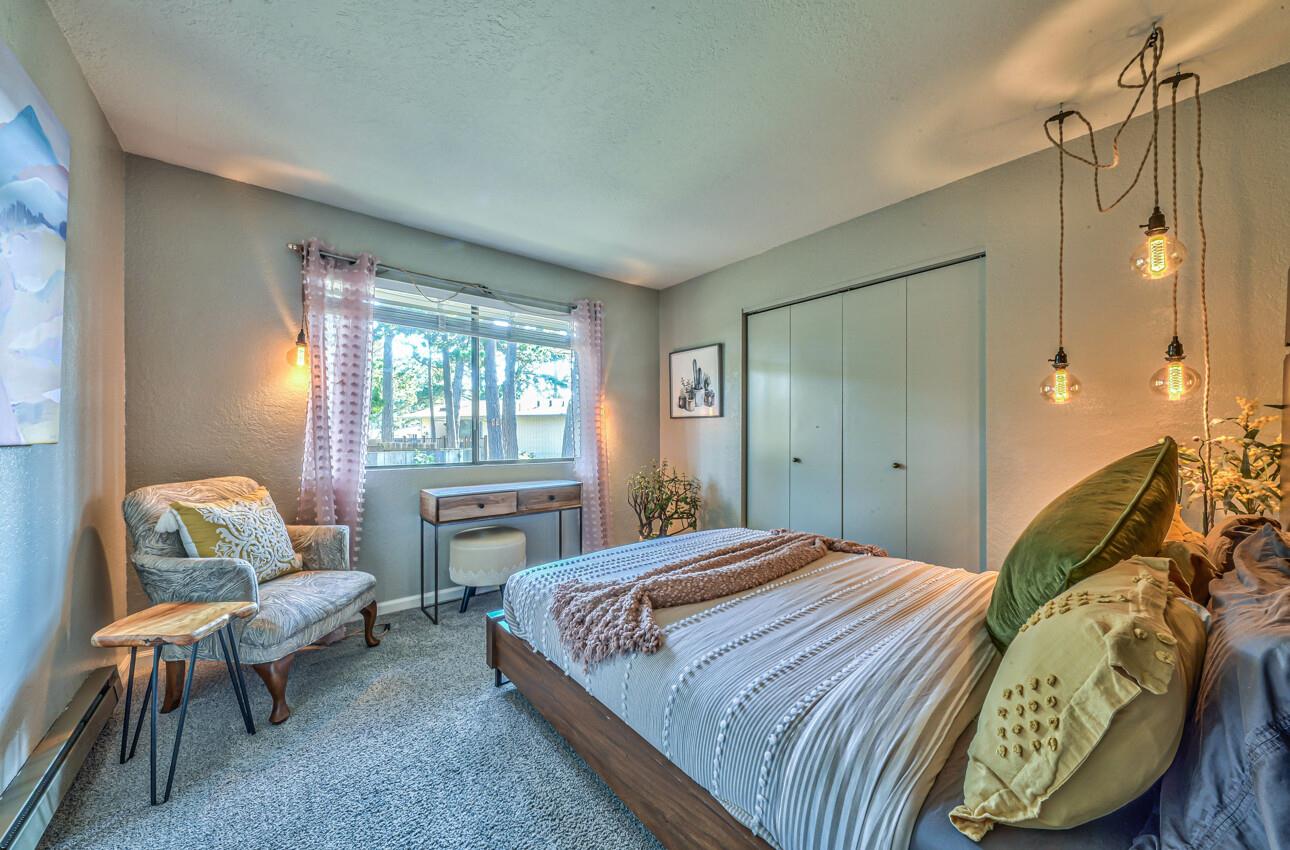 250 Forest Ridge Road, Unit 73 Monterey, CA 93940 - Photo 25 of 35 a bedroom with a bed and wooden floor