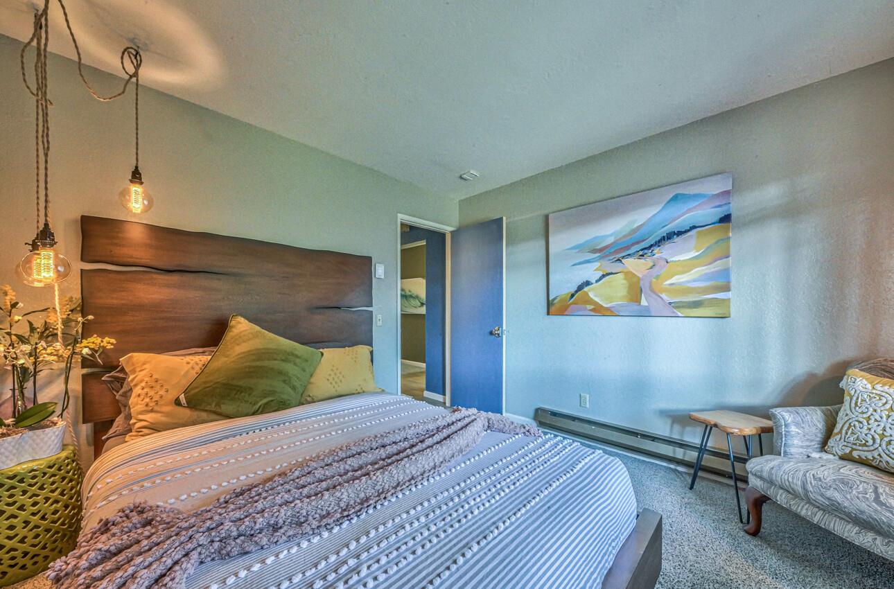 250 Forest Ridge Road, Unit 73 Monterey, CA 93940 - Photo 26 of 35 a bedroom with a bed and cupboard