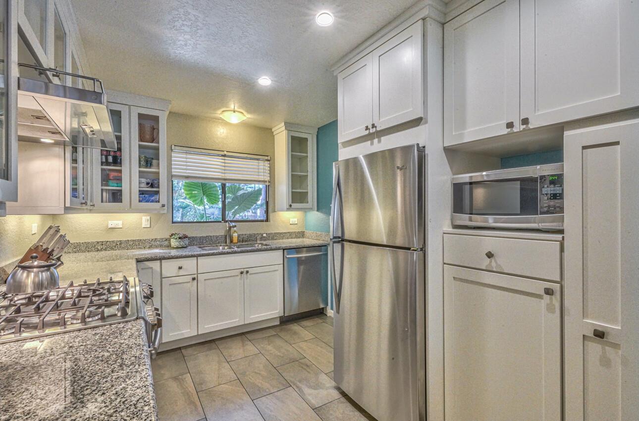250 Forest Ridge Road, Unit 73 Monterey, CA 93940 - Photo 6 of 35 a kitchen with stainless steel appliances a refrigerator sink and cabinets