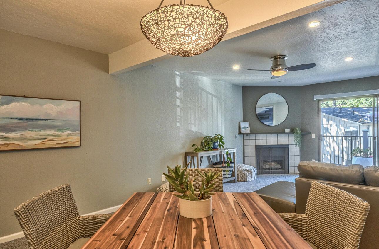 250 Forest Ridge Road, Unit 73 Monterey, CA 93940 - Photo 7 of 35 a living room with furniture a fireplace and a table