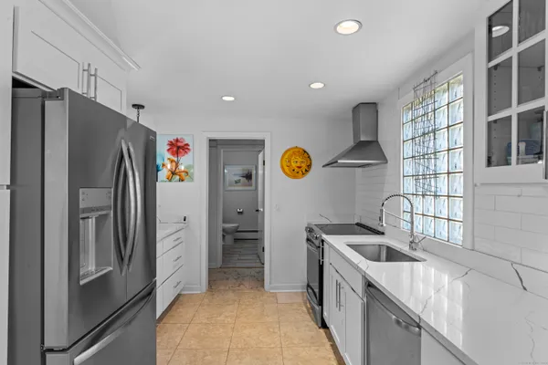 a kitchen with a refrigerator and a sink