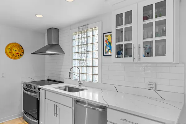 a kitchen with a stove and a sink