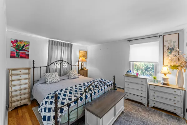 a bedroom with a bed and a dresser