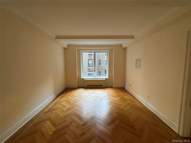 a view of an empty room and a window