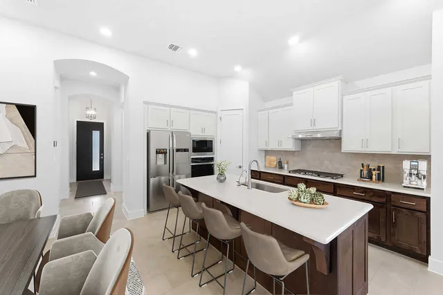 a kitchen that has a table and chairs in it