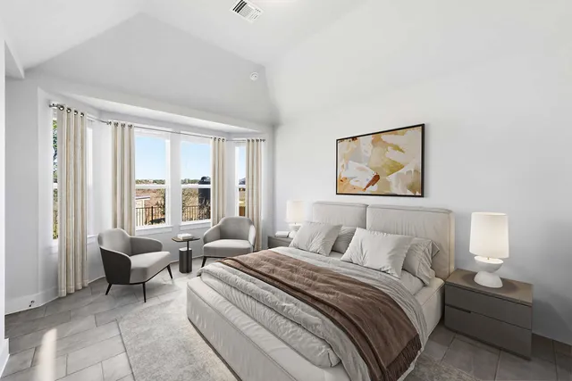 a bedroom with a bed and a large window