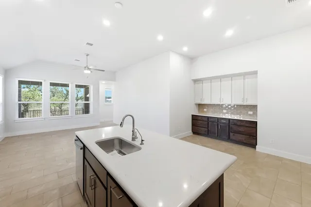 a kitchen with a sink a counter top space and appliances