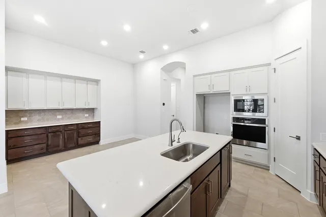 a kitchen with a sink a stove and oven