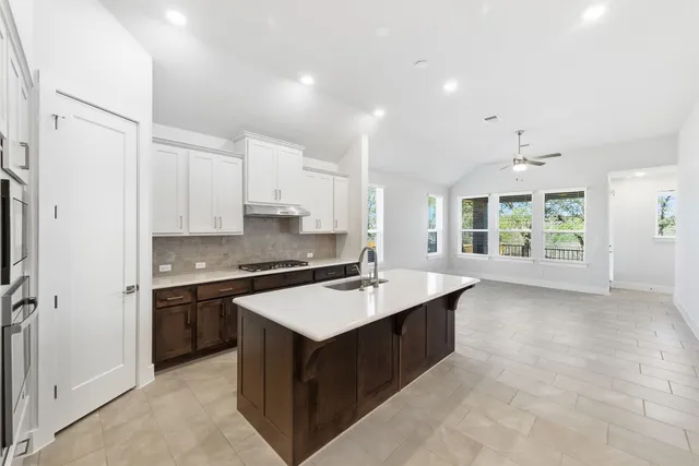 a kitchen with stainless steel appliances granite countertop a stove and a refrigerator