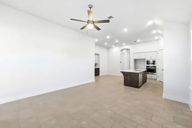 a view of a kitchen with a sink and a refrigerator