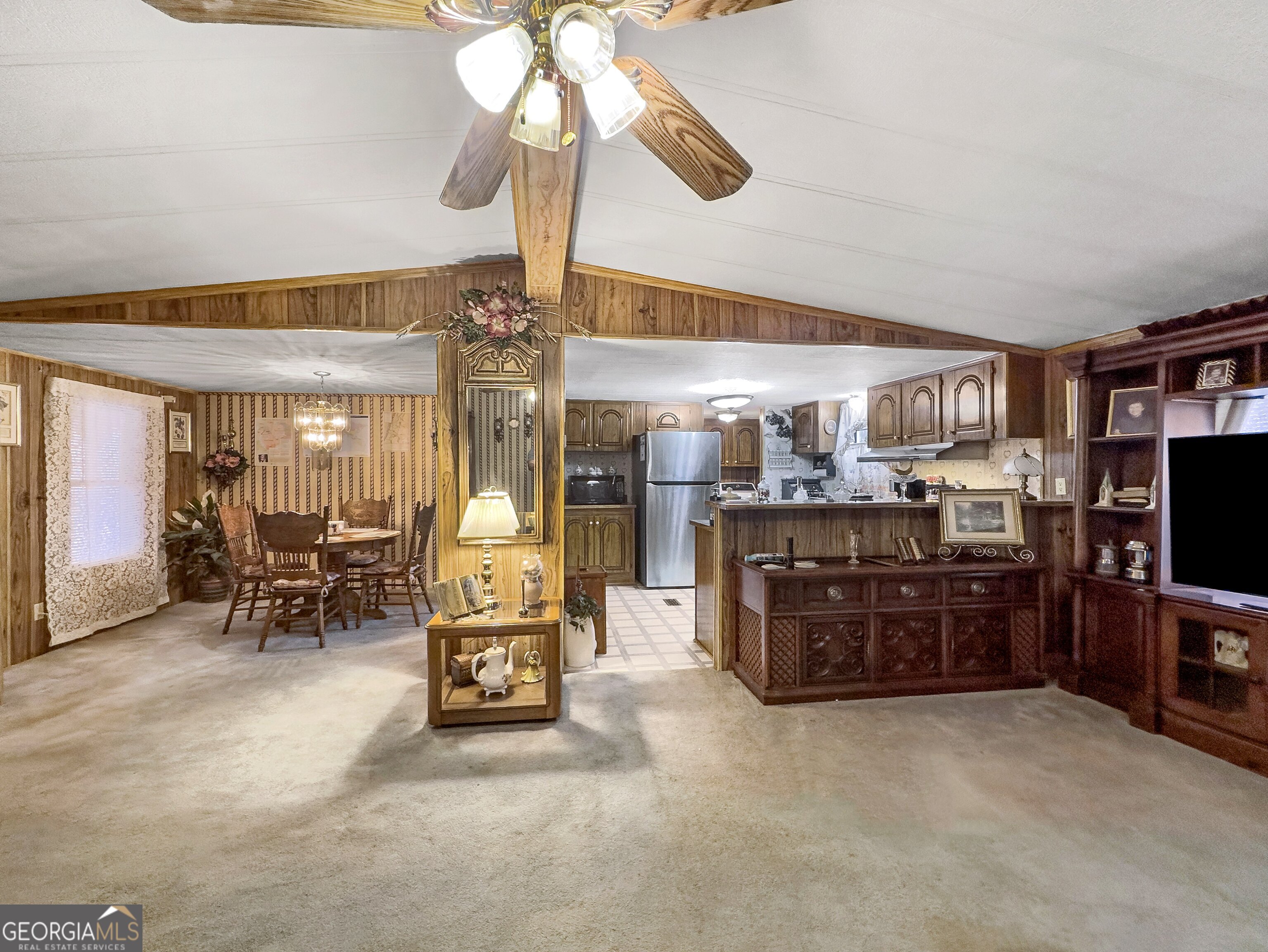451 Weldon Lake Road Milner, GA 30257 - Photo 11 of 39 a living room with furniture a chandelier and a flat screen tv