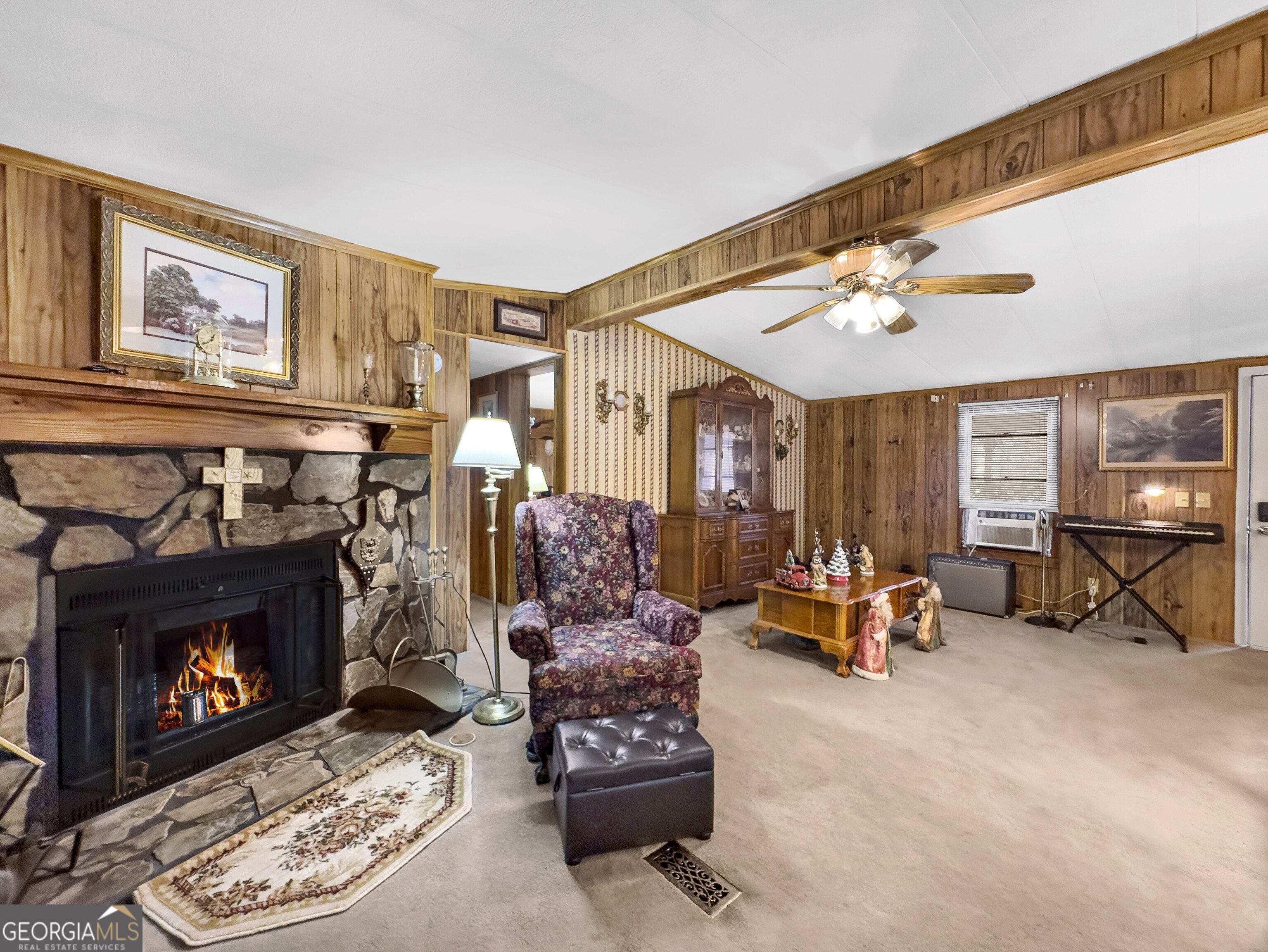 451 Weldon Lake Road Milner, GA 30257 - Photo 12 of 39 a living room with furniture and a fireplace