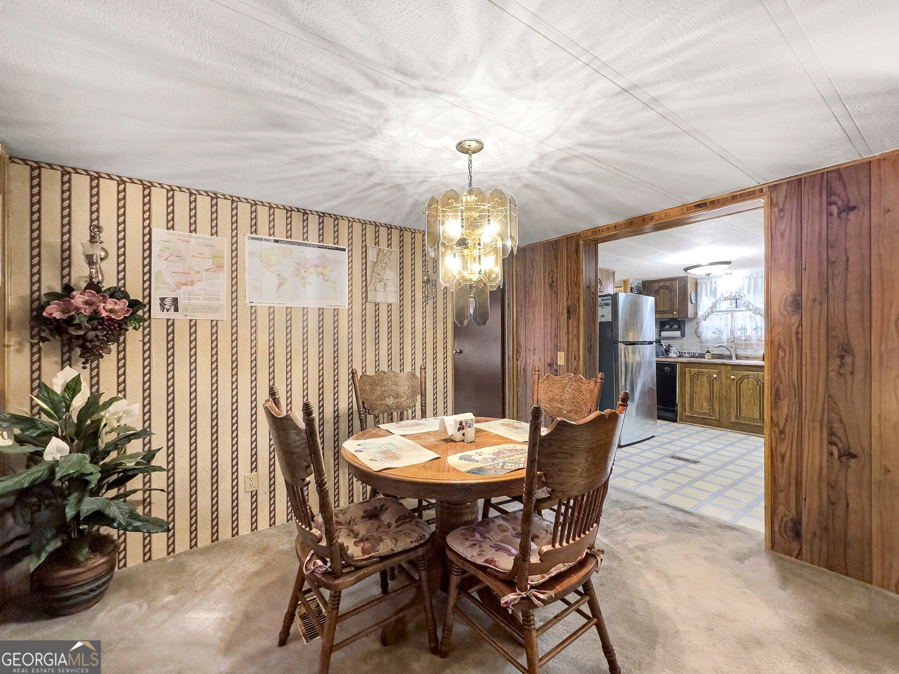 451 Weldon Lake Road Milner, GA 30257 - Photo 15 of 39 a view of a dining room with furniture and chandelier