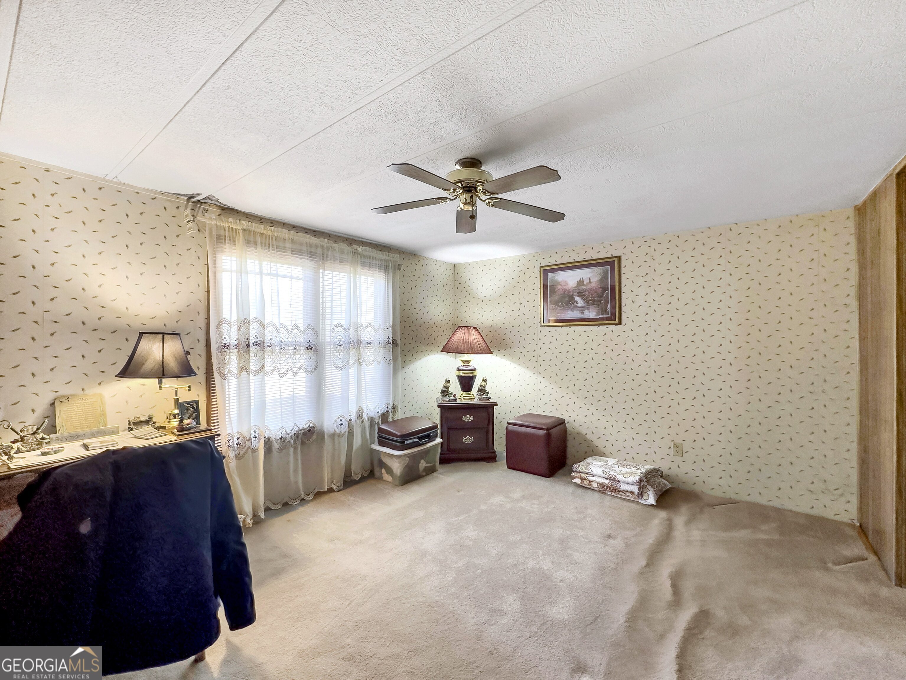 451 Weldon Lake Road Milner, GA 30257 - Photo 16 of 39 a bedroom with furniture and a large window