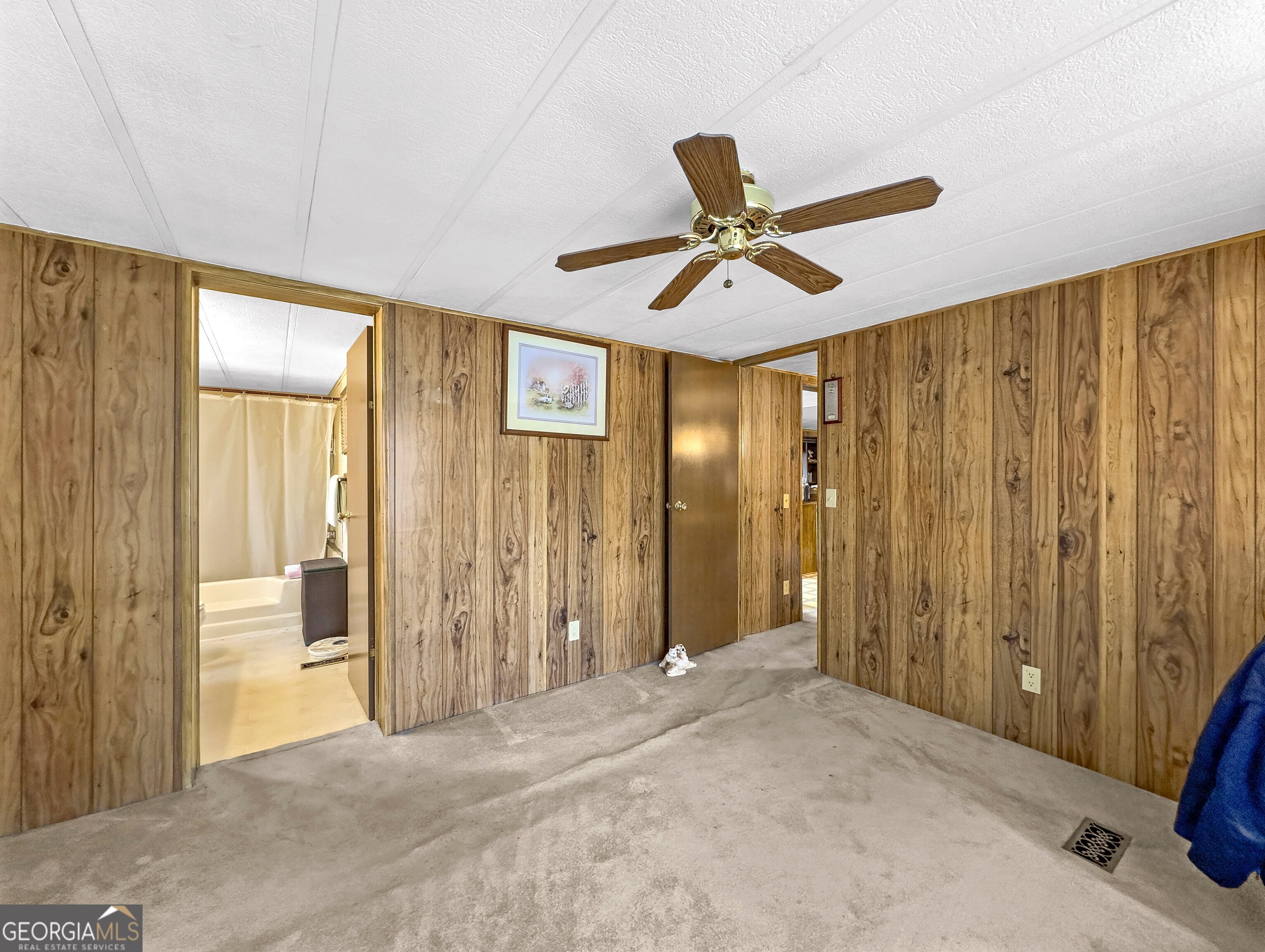 451 Weldon Lake Road Milner, GA 30257 - Photo 18 of 39 a view of a livingroom with a chandelier fan and a window
