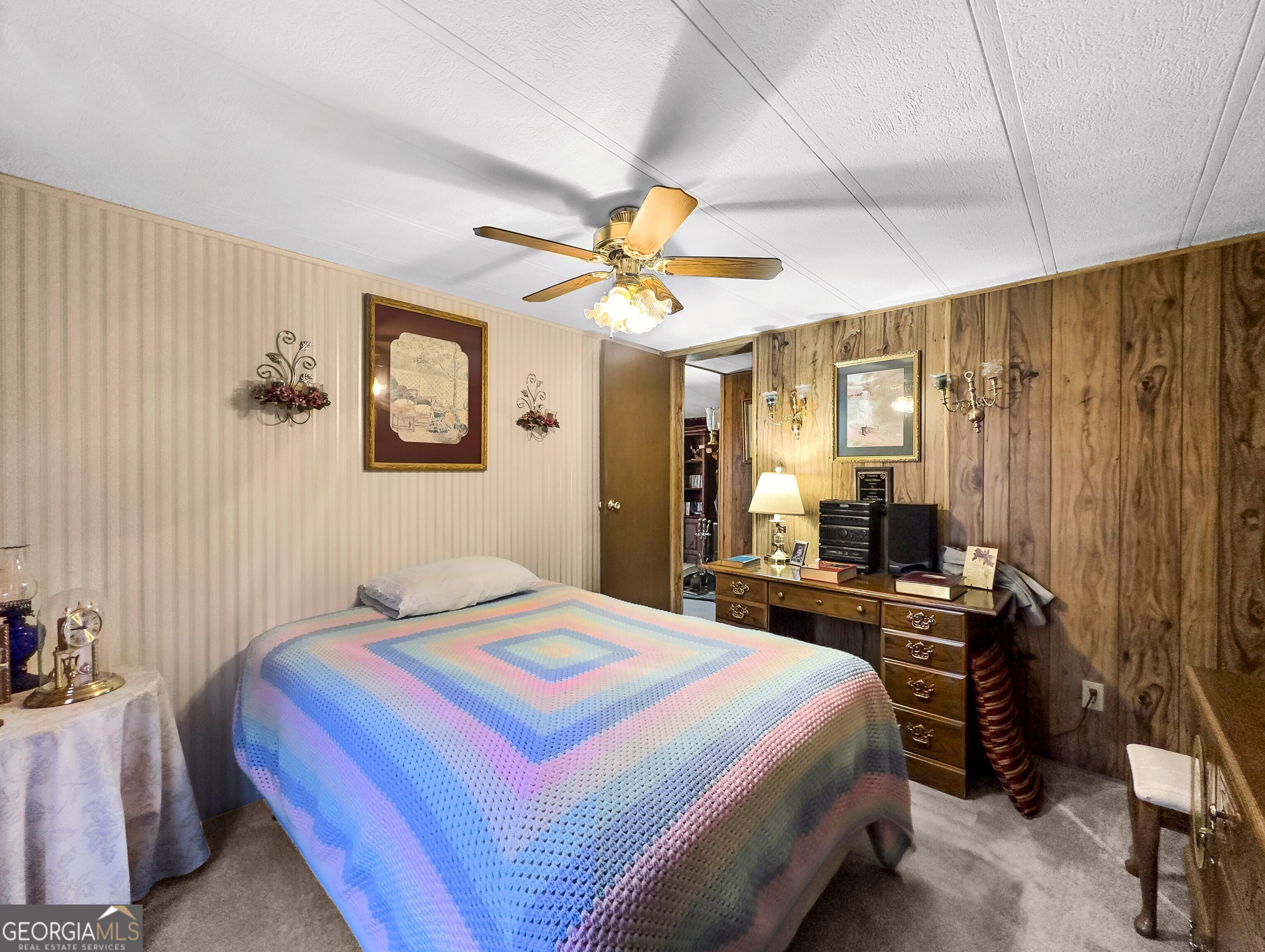 451 Weldon Lake Road Milner, GA 30257 - Photo 28 of 39 a bedroom that has a bed and a chandelier