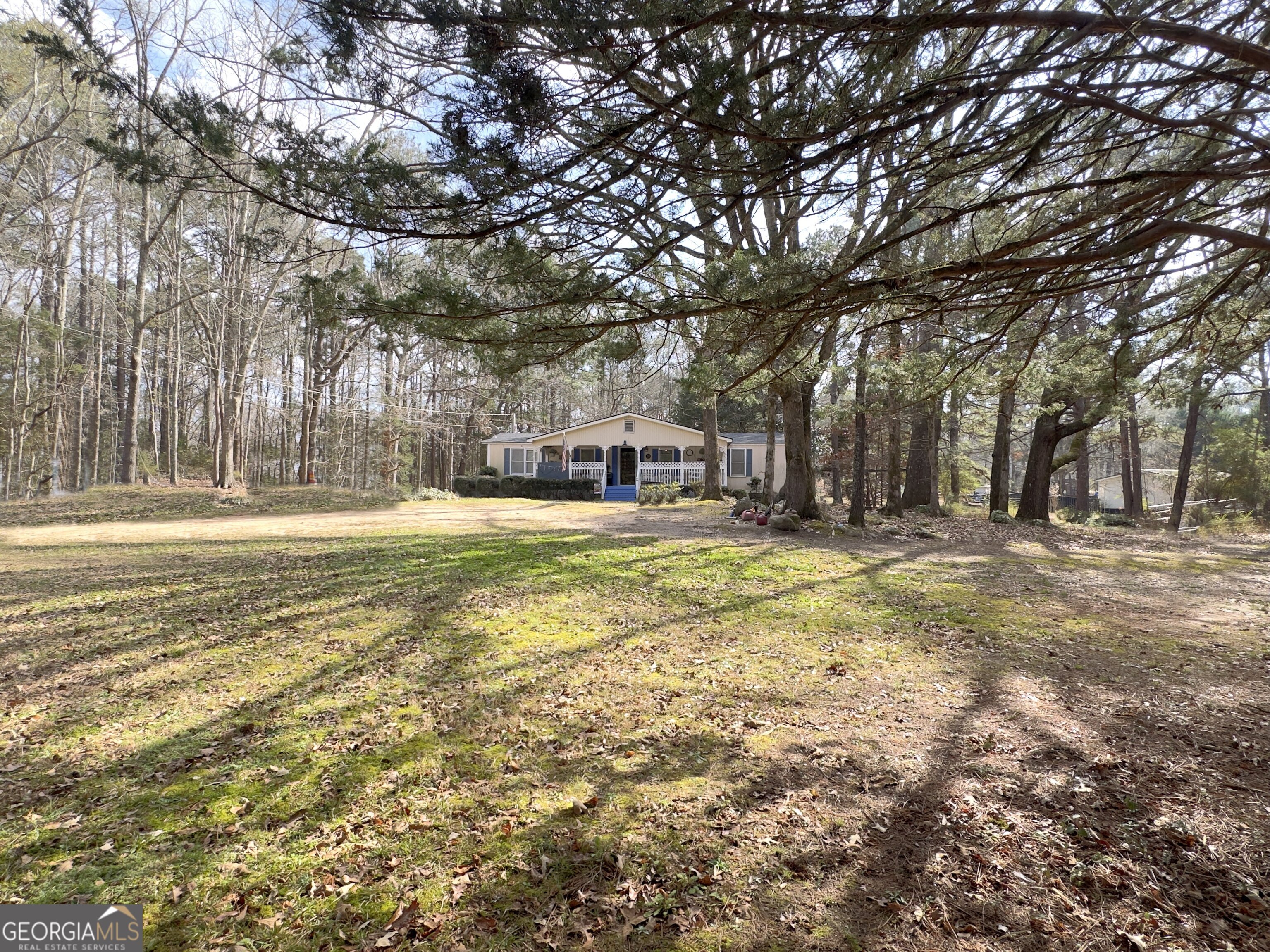 451 Weldon Lake Road Milner, GA 30257 - Photo 4 of 39 a swimming pool with outdoor seating and yard