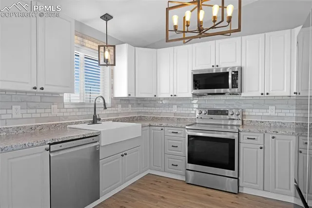a kitchen with appliances cabinets and a sink