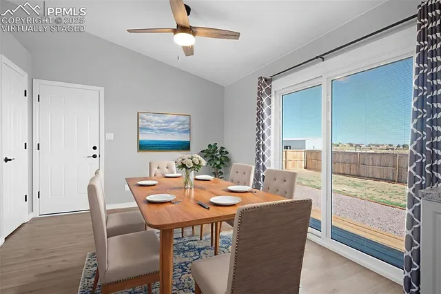 a view of a dining room with furniture window and wooden floor