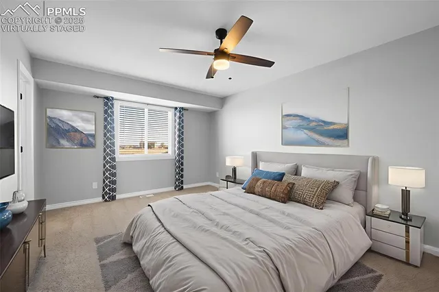 a bedroom with a large bed and a chandelier