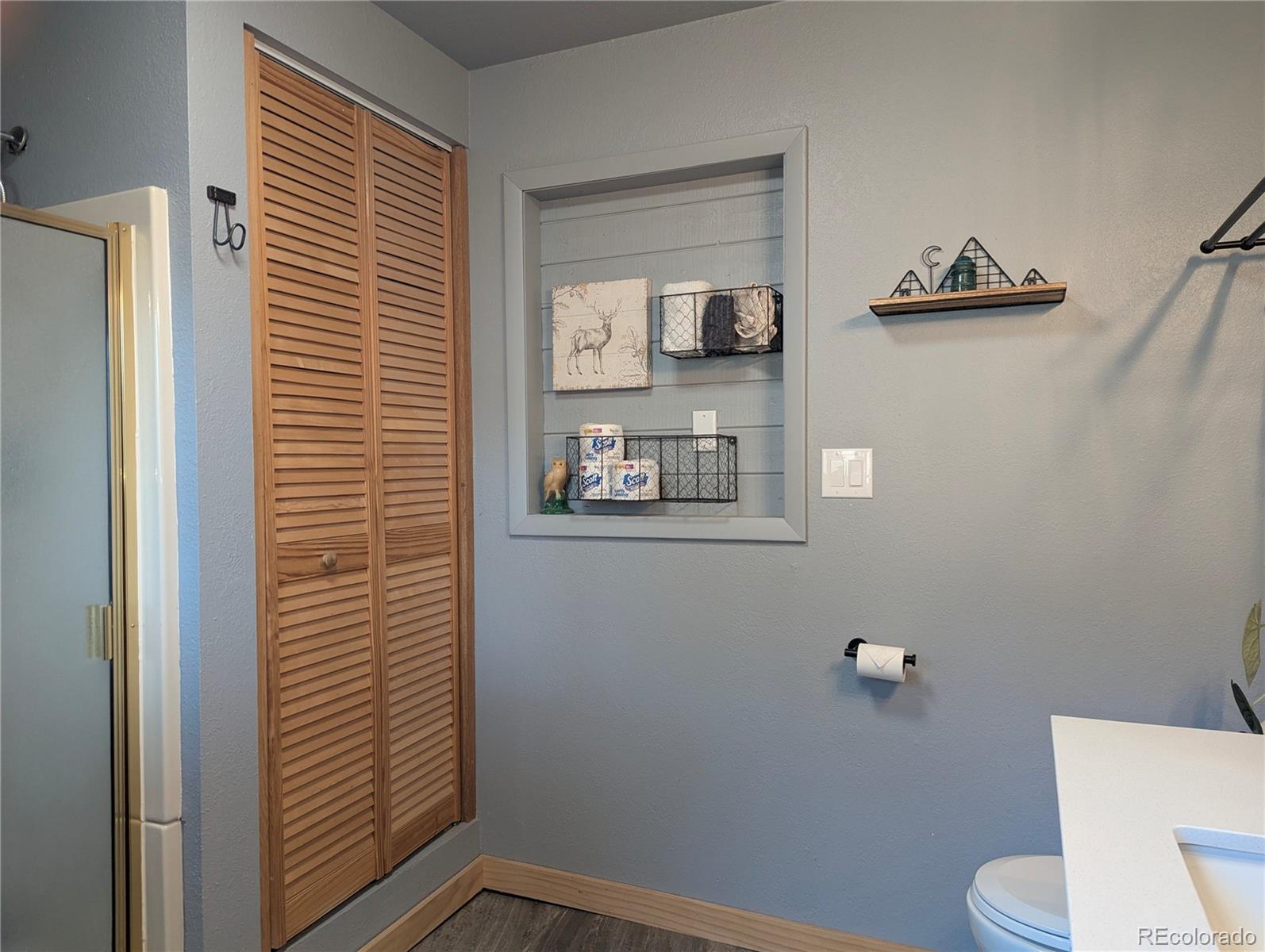 2084 Forbes Park Road Fort Garland, CO 81133 - Photo 27 of 39 a bathroom with a toilet and a shower curtain