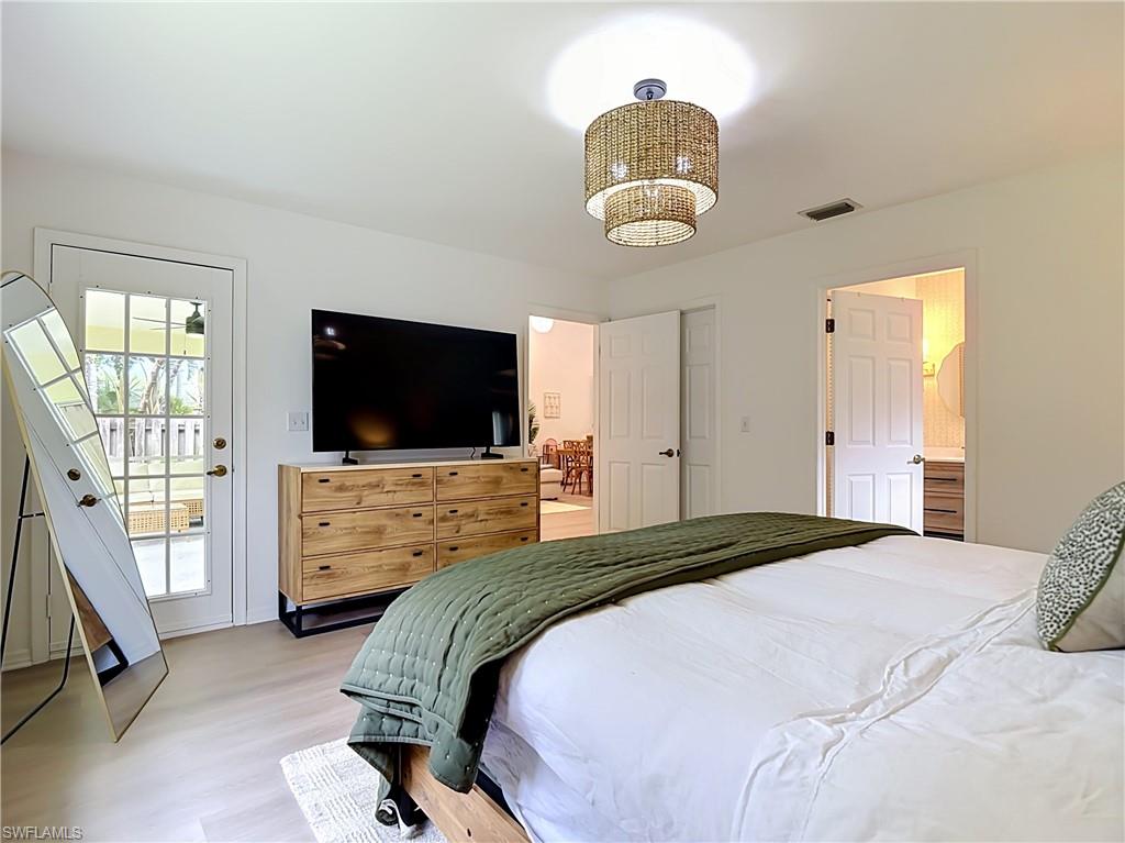 812 102nd Avenue North Naples, FL 34108 - Photo 16 of 33 White interior walls with light wood-finish flooring