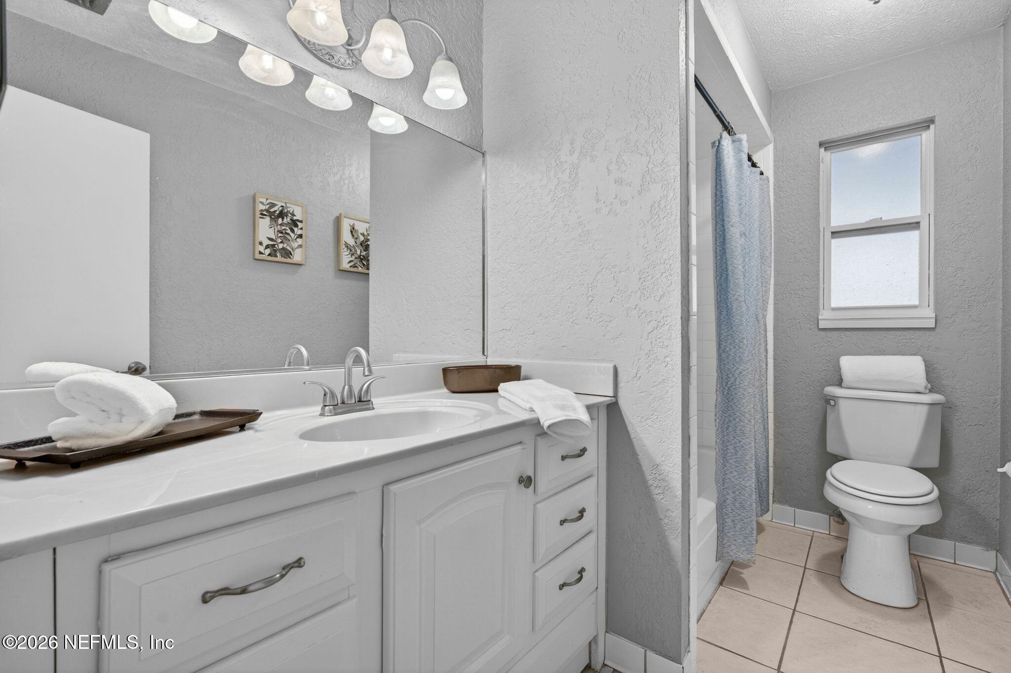 138 Ridgefield Court Orange Park, FL 32065 - Photo 29 of 64 a bathroom with a toilet a sink and a mirror