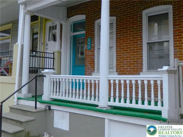 a view of a chair and table in the porch