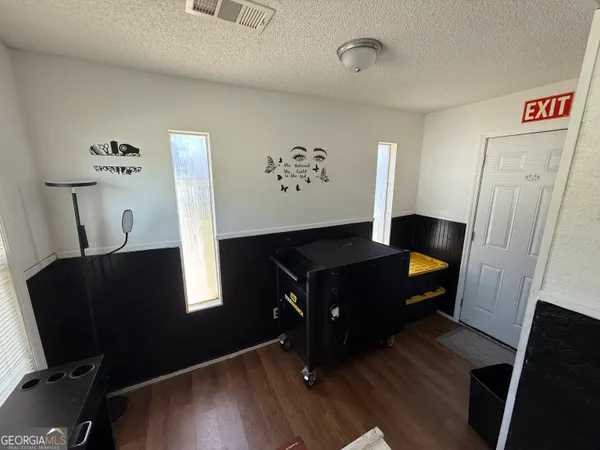 a living room with furniture mirror and wooden floor