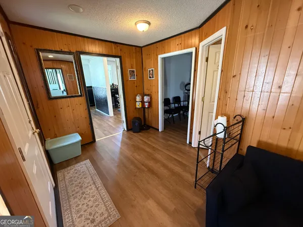 a view of a hallway with furniture and a window
