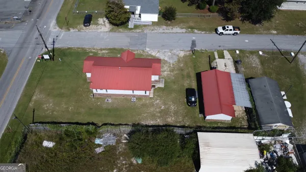 an aerial view of a house with a yard