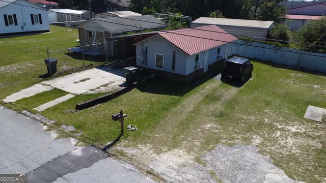 a aerial view of a house with garden space and street view