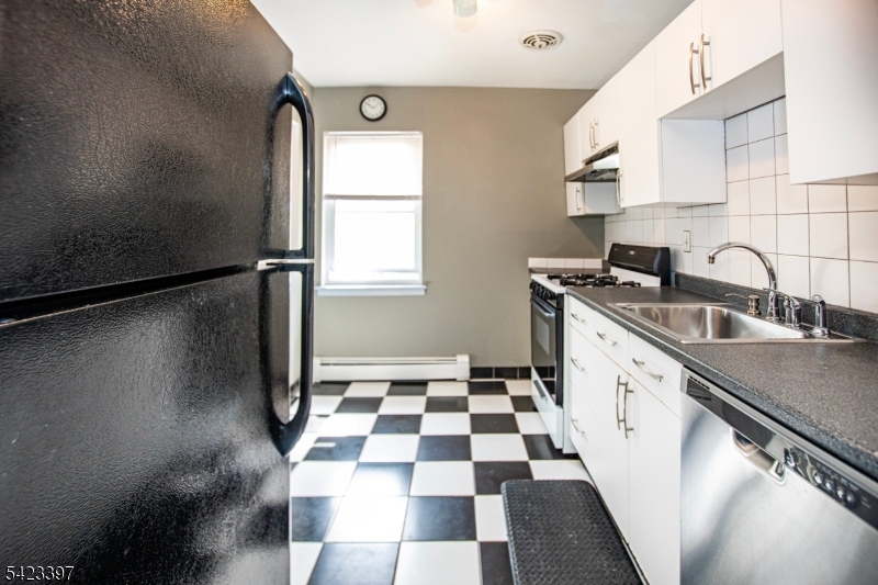 1130 Valley Road, Unit 2B Wayne, NJ 07470 - Photo 18 of 47 a kitchen with a sink a refrigerator and cabinets