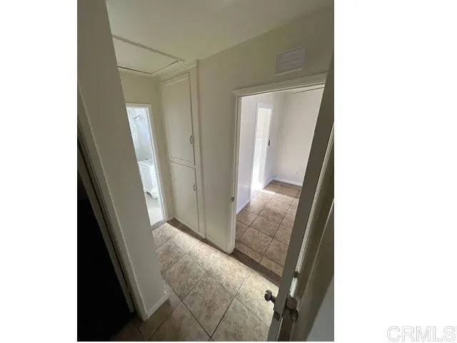 a living room with a bed and a mirror